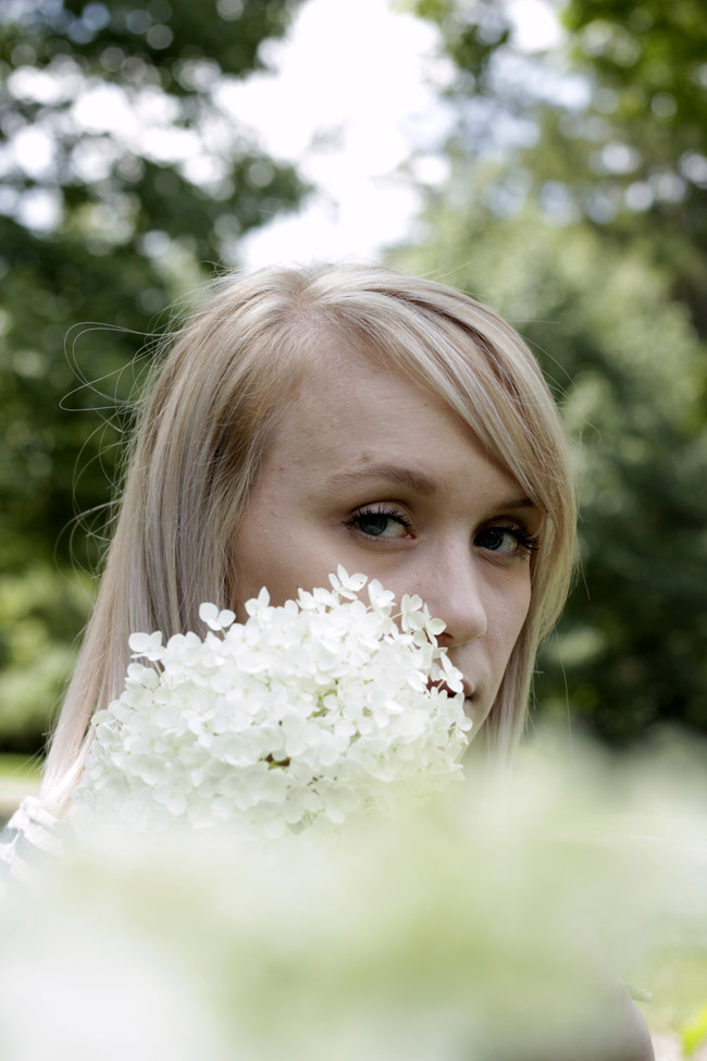 Alexis hiding behind flowers