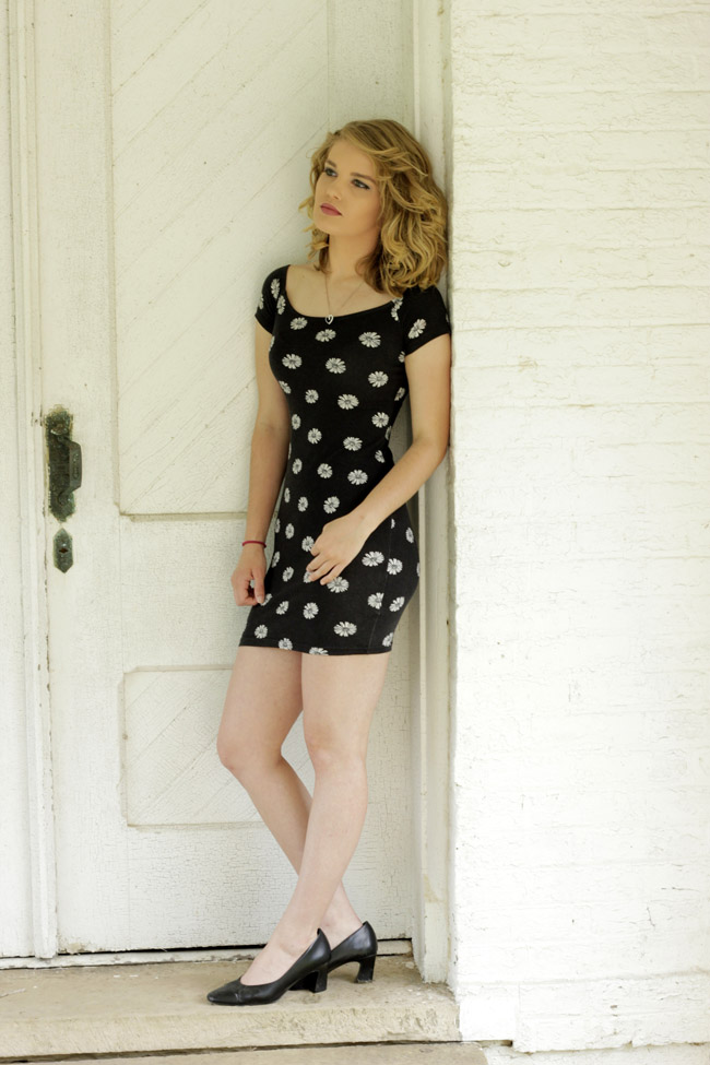 Breanna leaning on wall