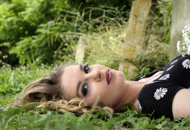 Breanna laying in grass