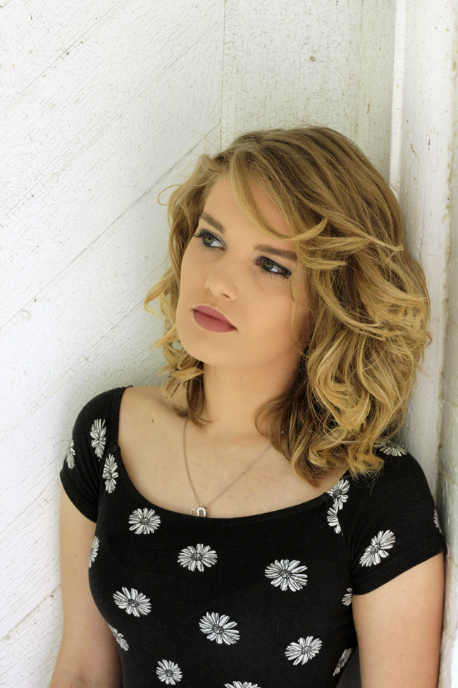 Close-up of Breanna leaning on wall