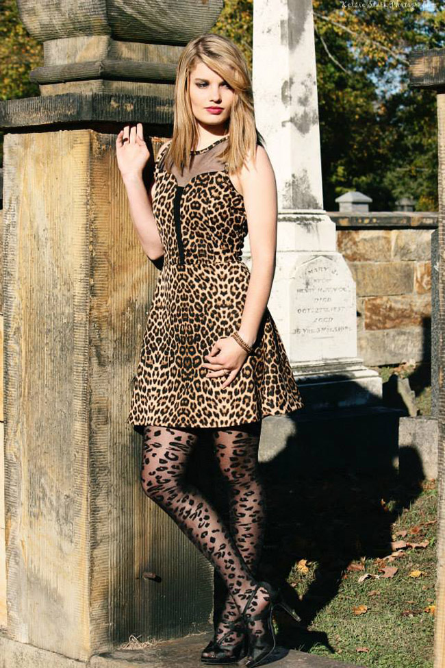 Girl leaning against statue