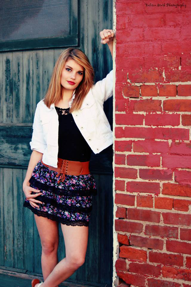 Girl leaning against wall
