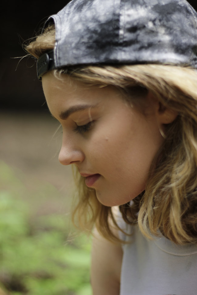 Close-up of girl wearing baseball hat