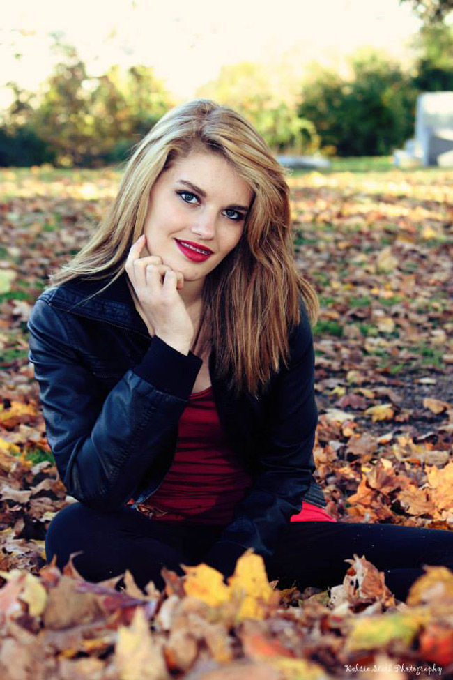 Girl sitting in leaves