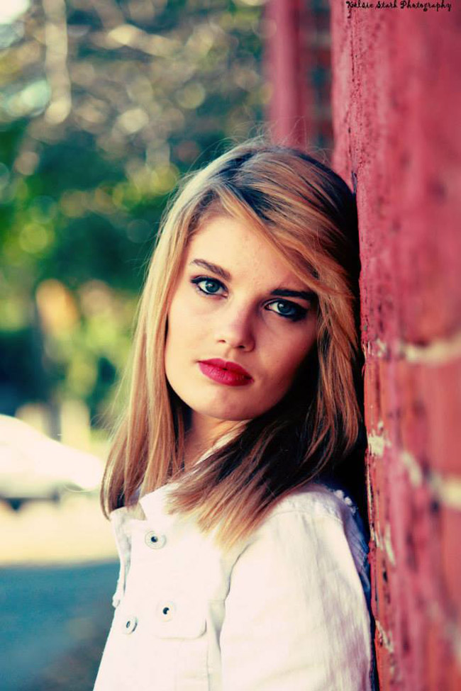 Girl leaning against wall
